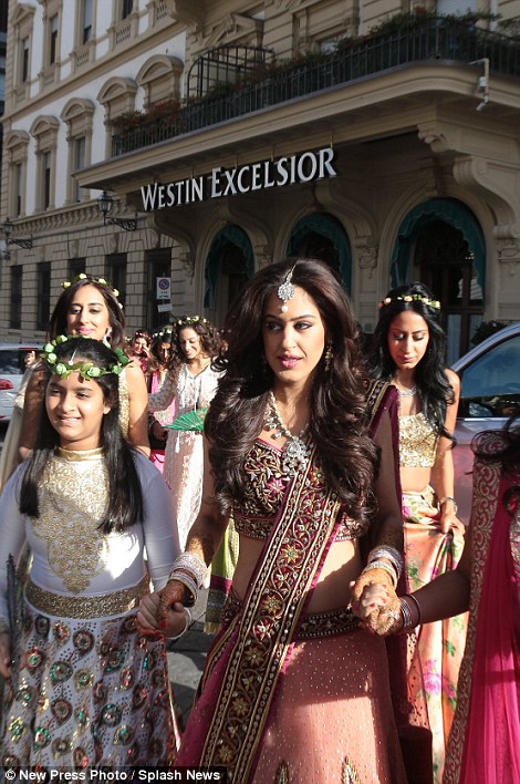 Roshni, pictured, was born and raised in London and owns a fashion business. Female guests at the wedding wore flowers in their hair as they made their way to the ceremony