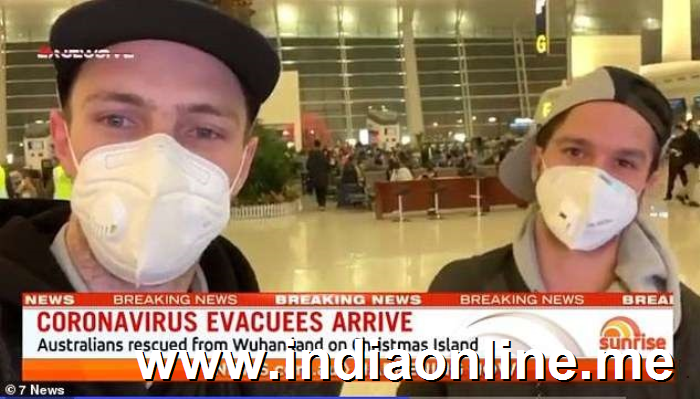 a person wearing a hat: Two Australians wore face masks as they spoke about their rescue flight out of Wuhan